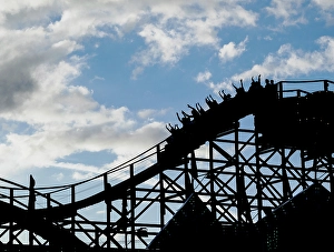 Images Dated 3rd September 2024: Silhouette of people raising their hands on a roller coaster