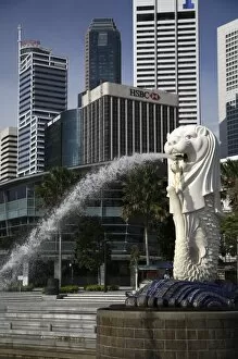 Singapore. Merlion statue in the Merlion Park with high rise office towers in Financial