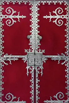 Sintra, Portugal. Quinta da Regaleira, The architecture evokes Roman, Gothic, Renaissance, and Manueline styles. Founded in 1904. Silver hardware adorns red velvet covered door. UNESCO World Heritage Site