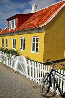 Bicycle Prints: Skagen, Denmark. Bike, yellow house with white picket fence and terra cotta roof