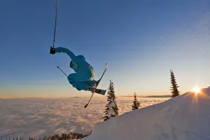Exciting Prints: Skier catching air at sunset during an inversion at Whitefish Mountain Resort in Montana