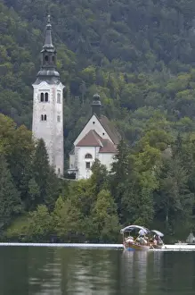 Images Dated 26th September 2004: Slovenia, Bled, Lake Bled, pletna boat and Bled Island chapel