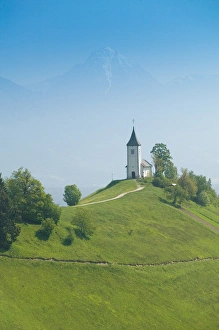 Images Dated 26th May 2004: SLOVENIA-GORENJSKA-Jamnik: Church of St. Prim & Kamnik-Savinja Alps / Morning