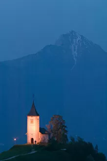 Images Dated 26th May 2004: SLOVENIA-GORENJSKA-Jamnik: Church of St. Prim & Kamnik-Savinja Alps / Evening