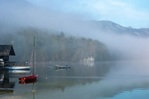Images Dated 17th June 2024: Slovenia, Lake Bohinj. Lake boats on foggy morning