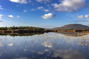 County Galway Prints: Small lake reflecting clouds near Clifden, Ireland