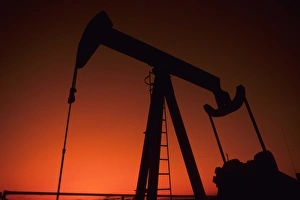 Oklahoma Prints: Small oil rig getting oil from the ground in sunset, Tulsa, Oklahoma USA