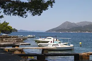 Dalmatia Prints: Small pleasure boats moored on jetty jetties looking out to the Kanal Daksa canal