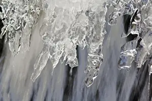 Small waterfall encased in ice near Logan Pass at Glacier National Park in Montana