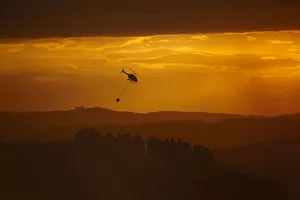 Images Dated 14th November 2018: Smokey sunset and helicopter fighting fire at Burnside, Dunedin, South Island, New