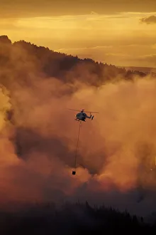 Smokey sunset and helicopter fighting fire at Burnside, Dunedin, South Island, New