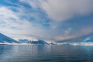 Polar Prints: Snow covered mountains rise near the shore of Mushamna Bay