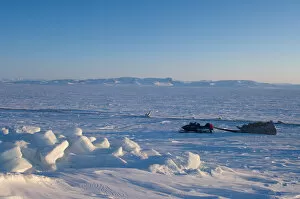 snow machine and sled on the frozen Arctic ocean, off Herschel island and the Mackenzie River delta