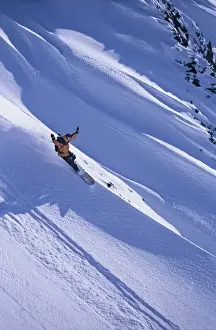 Snow Board Prints: Snowboarded rides a ridgeline in Big Cottonwood on his Voile Splitboard, Wasatch-Cache N
