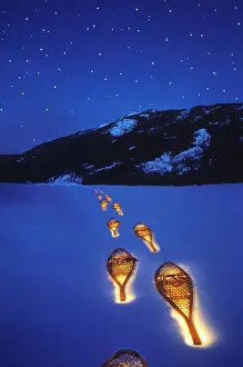 Images Dated 28th May 2010: Snowshoes lighted by flashlight across Lake McDonald in Glacier National Park in