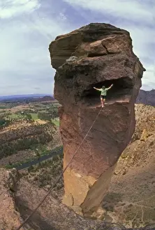 Cable Prints: Solo rock climber walking cable stretched from free-standing Monkey Face rock to