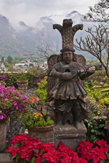 Poinsettia Prints: South America, Mexico, Tepoztlan. Flower pots in garden with statue. Credit as: Nancy