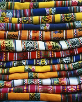 Images Dated 13th August 2007: South America, Peru, near Cusco. Stack of colorful blankets for sale in market. Credit as