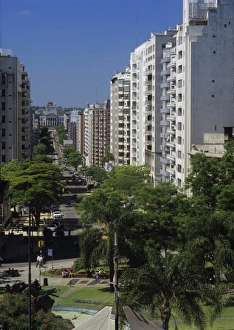 Busy Prints: South America, Uruguay, Montevideo, sun-washed while buildings line a bisy residential