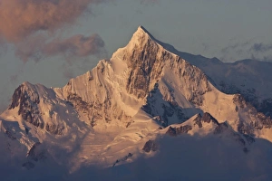 Images Dated 13th February 2011: South Atlantic, South Georgia. Sunlit, snow-covered mountain peak at dawn. Credit as