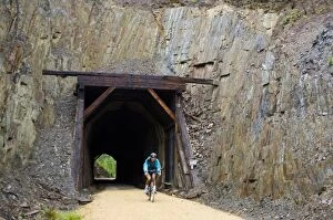 Images Dated 20th July 2006: South Dakota. USA. Bicyclist & tunnel through slate along George S. Mickelson Trail
