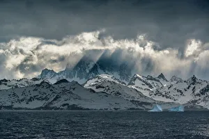 Images Dated 23rd January 2024: South Georgia Island. Opening in clouds and Virga reveal the mountainous and glaciated landscape