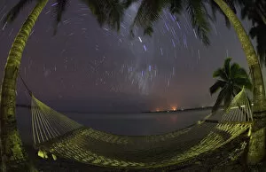 South Pacific, Cook Islands, Aitutaki. Stars rotate around the South Pole above a