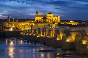 Roman Prints: Spain, Andalusia. Cordoba. The Roman bridge across the Guadalquivir river at dusk
