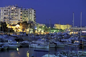 Balearics Prints: Spain, Balearics, Ibiza, Sant Antoni de Portmany. Evening view of city and marina