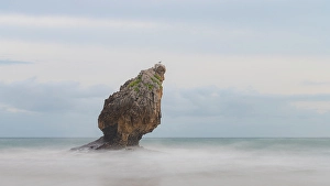 Sea Stack Prints: Spain, Playa Buelna. Lone ocean sea stack on misty coastline