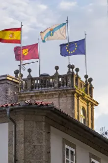 Santiago Prints: Spain, Santiago. European union and Portugal Flags flying atop a tower near the Cathedral