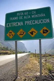 Warning Prints: Spanish language road sign warning of hazardous road conditions at the foot of
