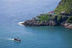 Warning Prints: St. Johna's, Newfoundland, Canada, a lobster boat sails by historic Fort Amherst