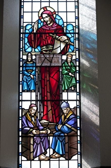 Reading Prints: Stained glass window in Lutheran Church of Akureyri, Iceland shows Christ reading