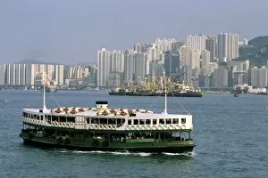 Star Ferry and skyscraper buildings at Hong Kong Harbor