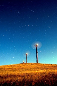 Turbine Prints: Startrails appearing to be blown by wind turbines under a full moon