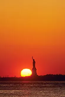Statue of Liberty, New York Harbor, NY, USA sunset