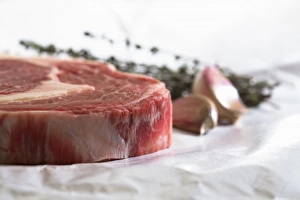 Herb Prints: Stockholm, Sweden - Closeup, cropped image of a steak, cloves of garlic and fresh herbs