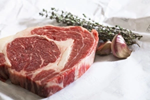 Herb Prints: Stockholm, Sweden - Closeup image of a steak, cloves of garlic and fresh herbs