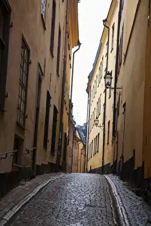 Vanishing Point Prints: Stockholm, Sweden - A narrow alley going between two old world buildings. Vertical shot