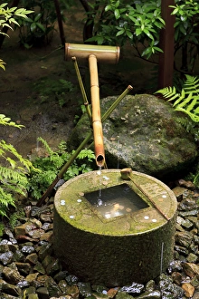 Buddhism Prints: A stone water basin in the grounds of Ryoan-Ji Temple in Kyoto, Japan