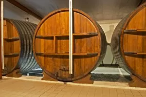 Images Dated 28th May 2005: A storage room in the winery with old wooden foudres (large wooden barrels) Chateau