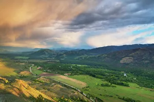 Salish Sea Prints: Storm clouds glowing from setting sun over Methow Valley, North Cascades, Washington State