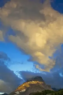 Images Dated 9th July 2009: Storm clouds light up at sunrise above Mount Wilbur in the Many Glacier Valley of