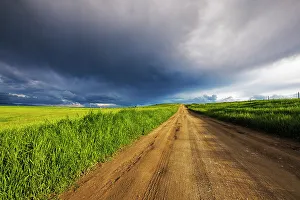 Gravel Prints: Storm clouds over West Spring Creek Road in the Flathead Valley, Montana, USA