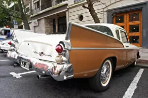 Cars Collection: A Studebaker Silver Hawk Classic Car parked on a street, painted in cream white and brown