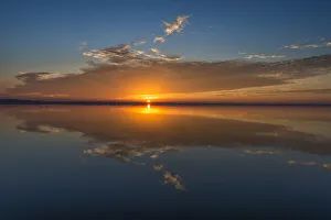 Sheila Haddad Prints: Stunning colors of sunrise and clouds reflected on Lake Hancock from Circle B Bar Preserve