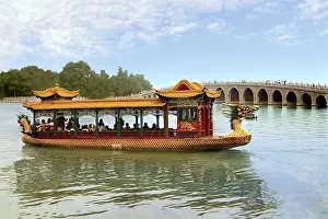 Images Dated 11th September 2007: The Summer Palace, Beijing, China, a traditional Dragon Boat passes the Seventeen