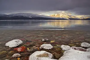 Pebble Prints: Sun breaks through the clouds at Lake McDonald on a winter evening in Glacier National