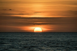 Images Dated 2025: Sun sets amid light clouds in the Gulf of Mexico